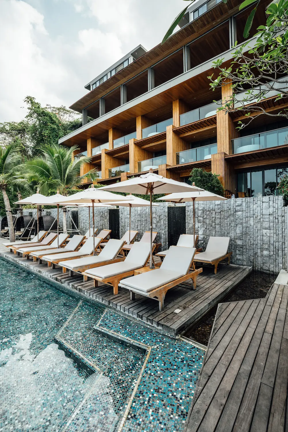 Resort pool and loungers at dusk